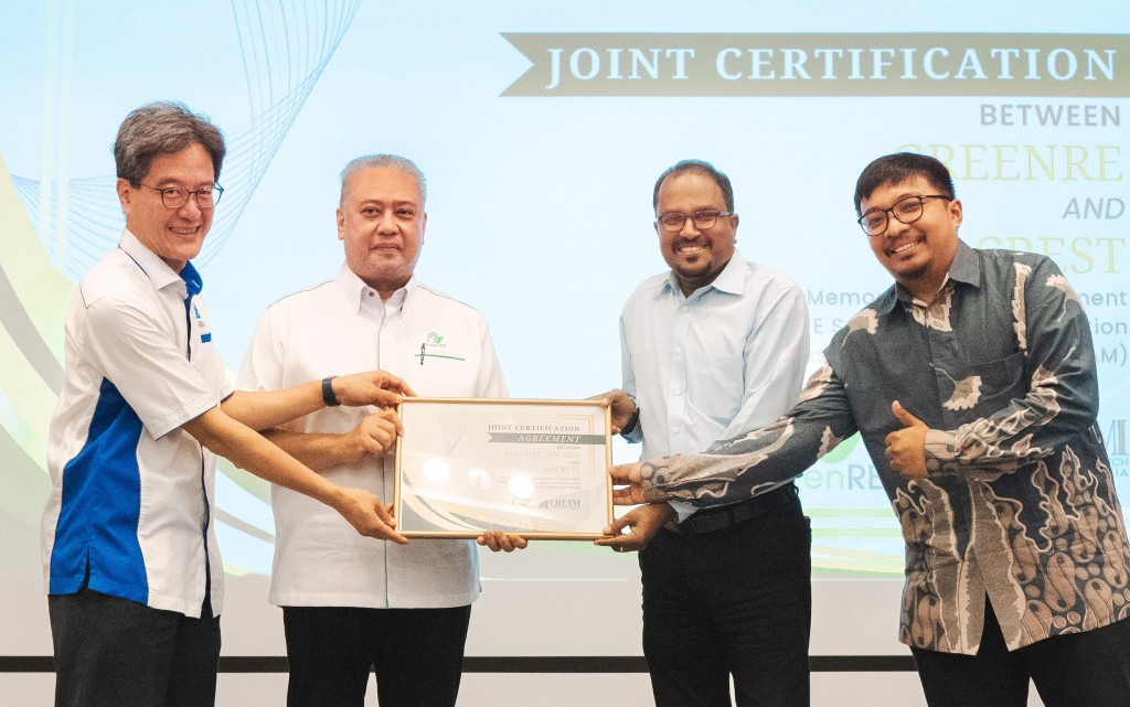 From left: Tong, Iskandar, Ramuseren and Ruslan holding a framed copy of the document.